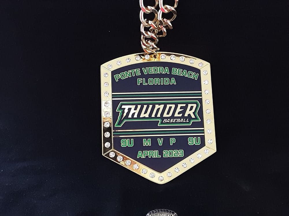 Custom baseball championship chain with a stone-set shield medallion carrying a team crest