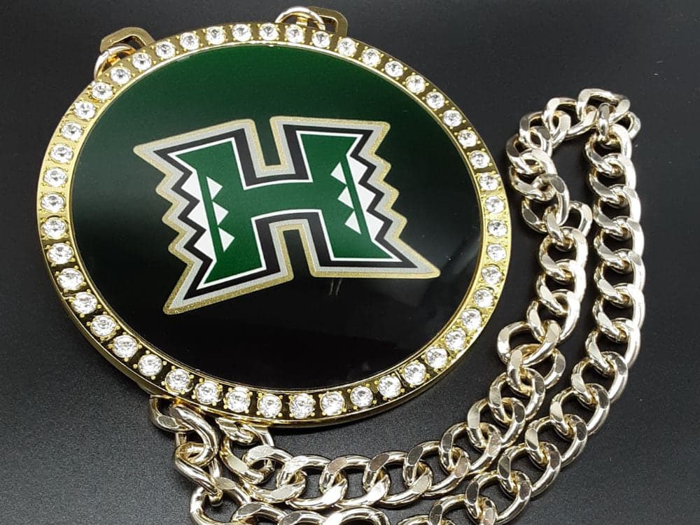 Custom championship chain with a round stone-set team medallion on a gold curb chain