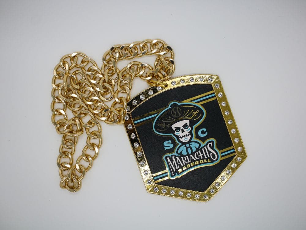 Custom championship chain with a stone-set team medallion coiled in a heavy gold curb chain