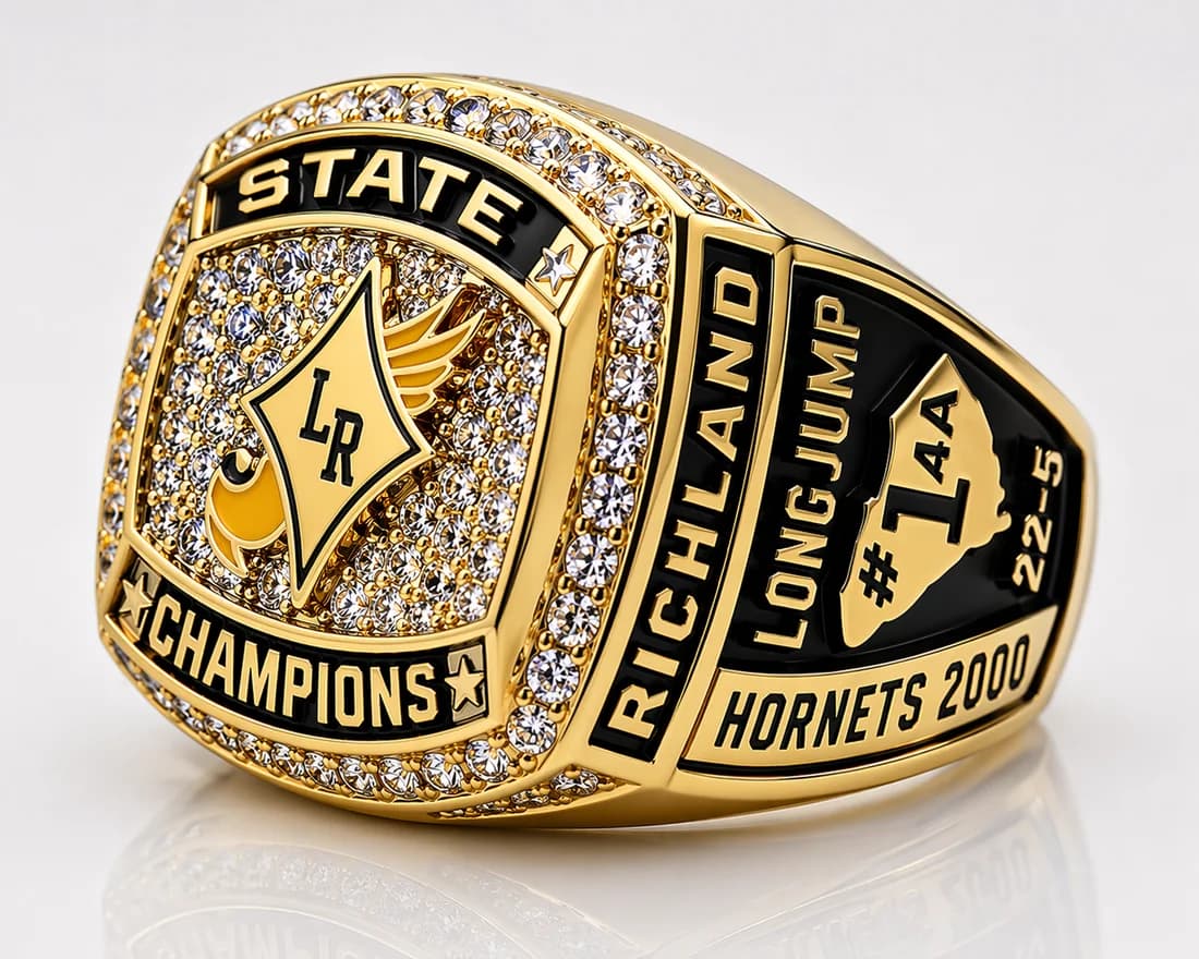 Track & Field Championship Rings by Colucci Custom Awards — a finished ring photographed in the workshop